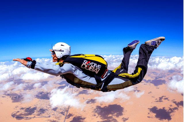 Skydiving wing suit flying over Brazilian beach Stock Photo | Adobe Stock